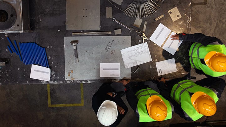Workers in PPE in consultation